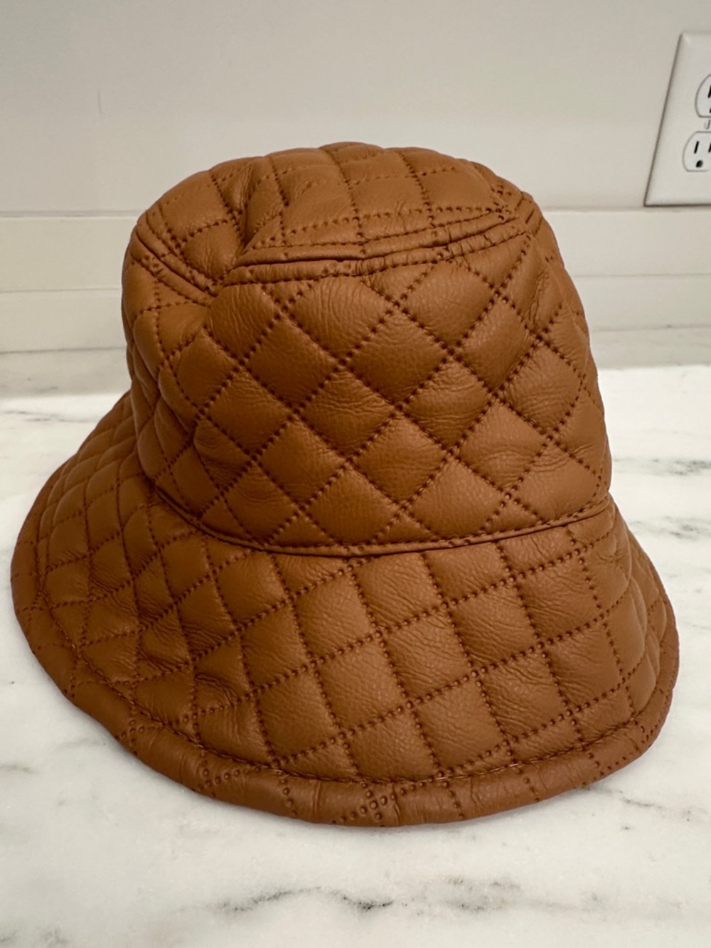 Pink Lily is Quilted Leather Bucket Hat - Brown.  Like new